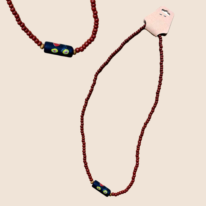 Necklace with burgundy red beads and statement bead